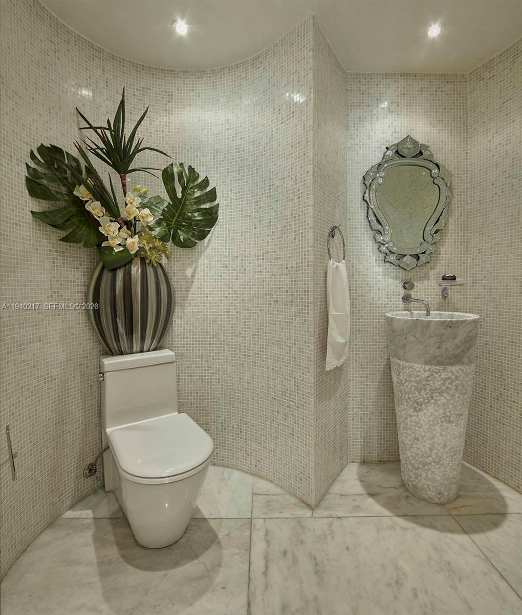 1643 Brickell Avenue, Unit 2902 Miami, FL 33129 - Photo 7 of 32 a bathroom with a toilet sink and shower