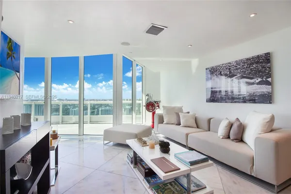 a living room with furniture and a large window