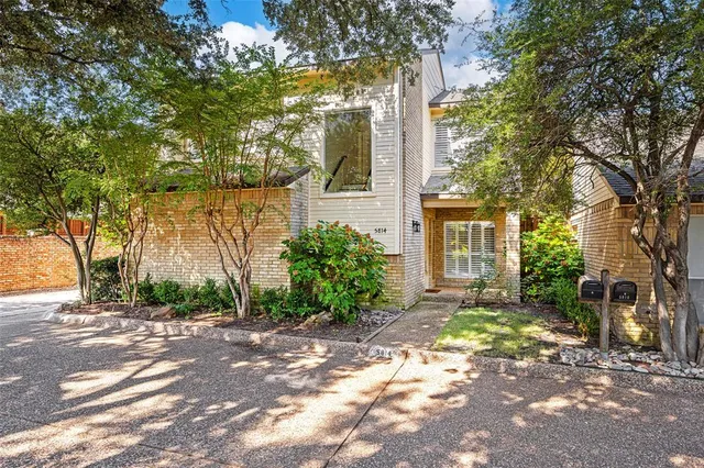 a view of a house with a tree in the background