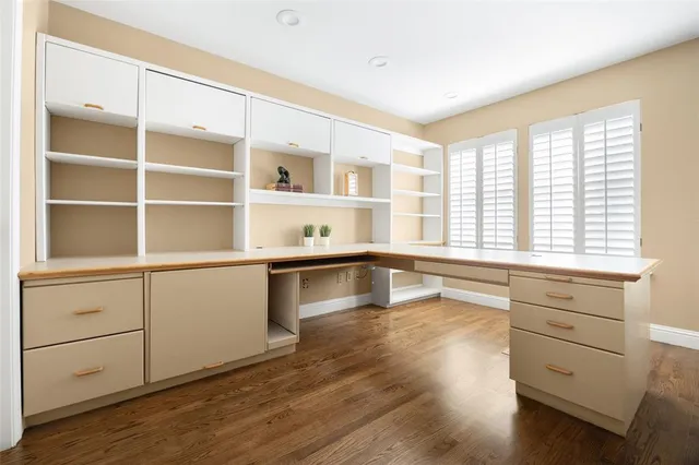 a living room with hard wood floors and a window
