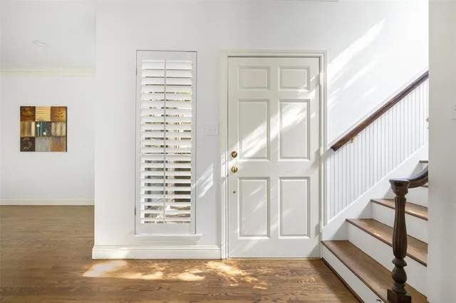a view of a livingroom with wooden floor and stairs