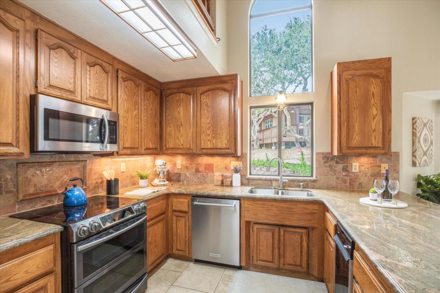 6333 Tustin Road Salinas, CA 93907 - Photo 11 of 88 a kitchen with stainless steel appliances granite countertop a sink a stove and a microwave
