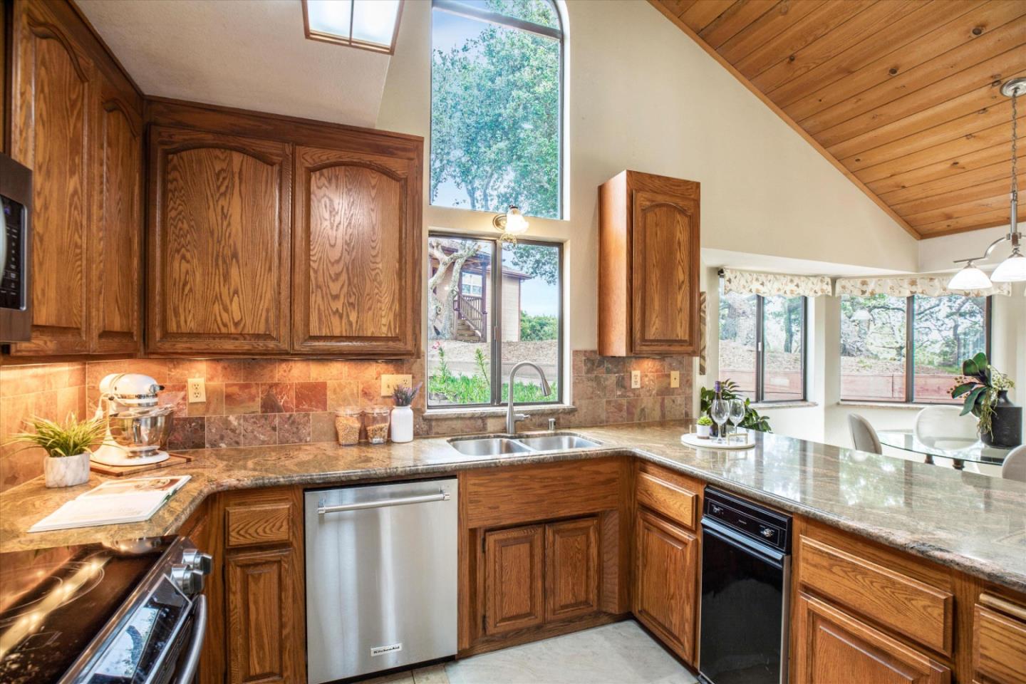 6333 Tustin Road Salinas, CA 93907 - Photo 12 of 88 a kitchen with stainless steel appliances granite countertop wooden cabinets a sink and a large window