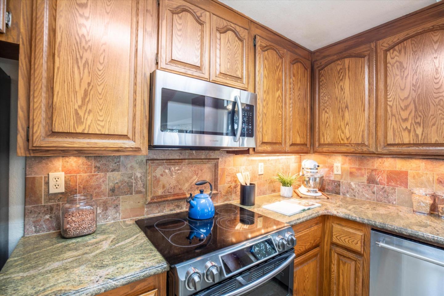 6333 Tustin Road Salinas, CA 93907 - Photo 13 of 88 a kitchen with stainless steel appliances granite countertop a sink stove and cabinets