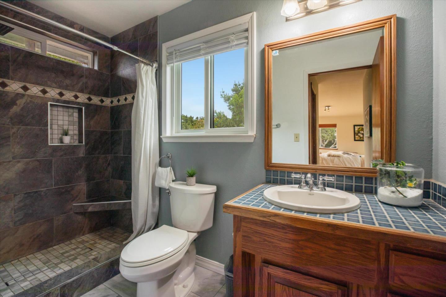 6333 Tustin Road Salinas, CA 93907 - Photo 42 of 88 a bathroom with a granite countertop toilet a sink and a shower