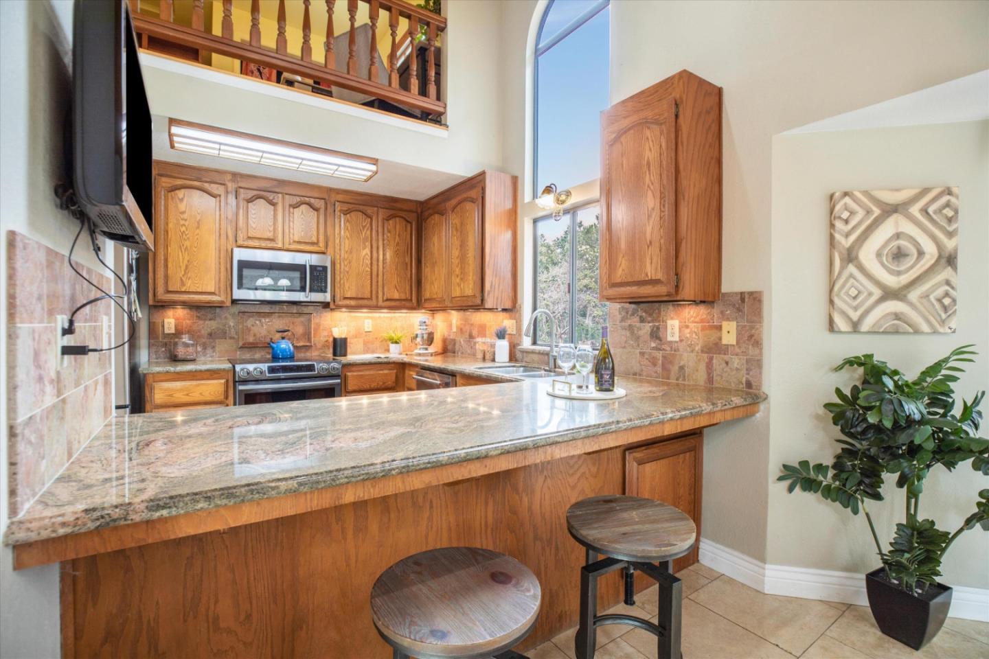 6333 Tustin Road Salinas, CA 93907 - Photo 10 of 88 a kitchen with stainless steel appliances granite countertop a sink a stove and a wooden cabinets