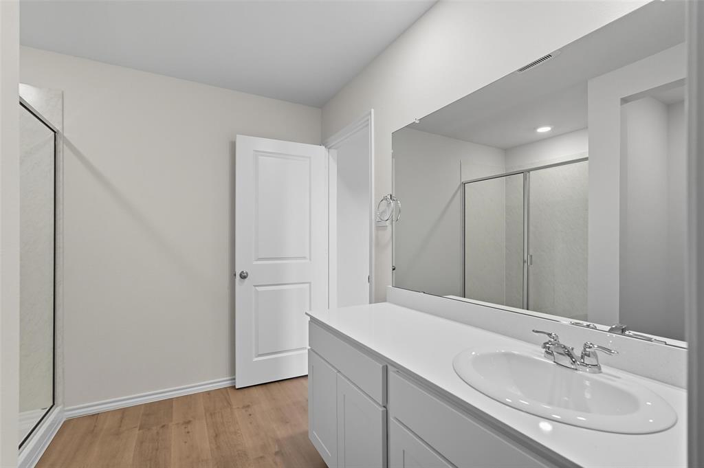 110 Labein Avenue Greenville, TX 75402 - Photo 14 of 20 a bathroom with a sink and a mirror