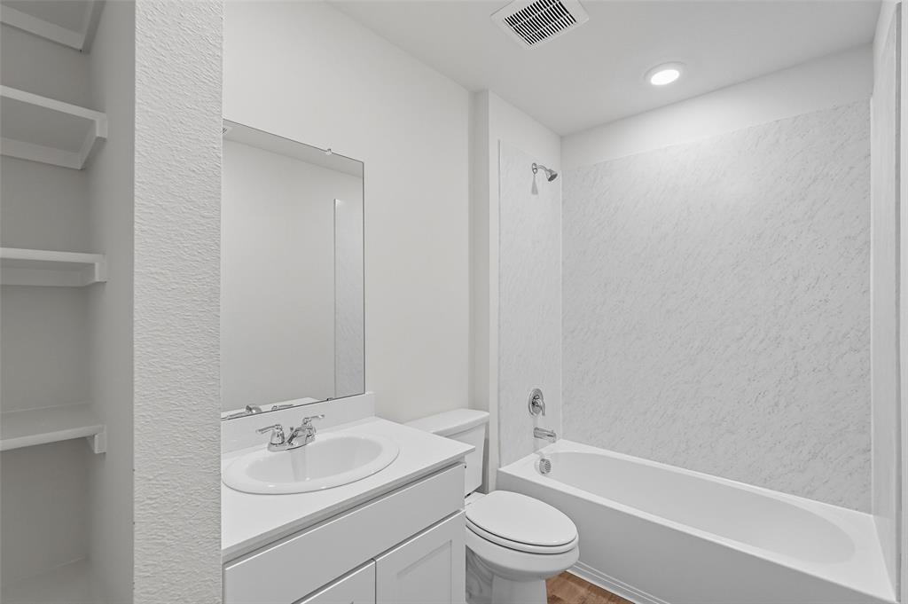 110 Labein Avenue Greenville, TX 75402 - Photo 16 of 20 a bathroom with a granite countertop sink toilet and shower