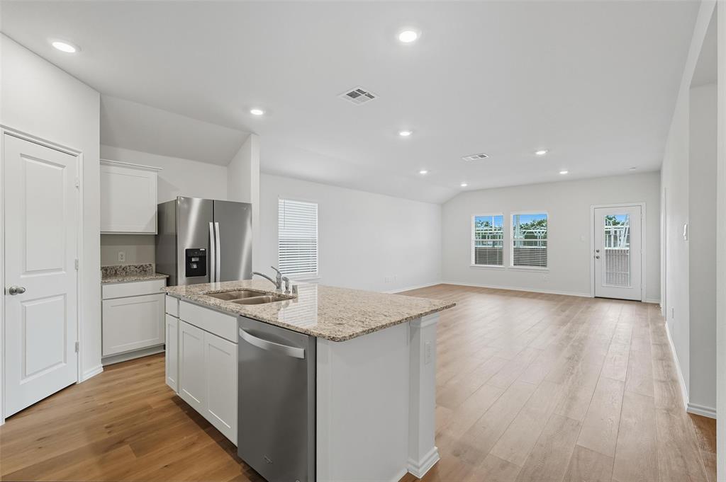 110 Labein Avenue Greenville, TX 75402 - Photo 4 of 20 a kitchen with stainless steel appliances granite countertop a sink stove and refrigerator