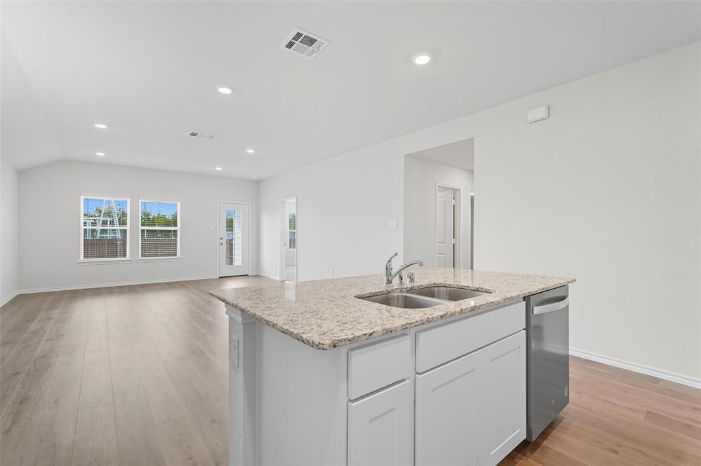 110 Labein Avenue Greenville, TX 75402 - Photo 19 of 20 a bathroom with a granite countertop sink and a vanity