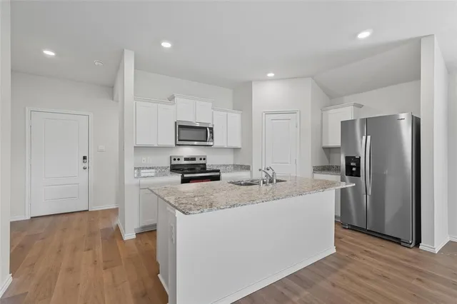 a bathroom with a granite countertop sink and a vanity