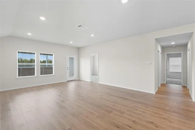a kitchen with stainless steel appliances granite countertop white cabinets and a stove top oven