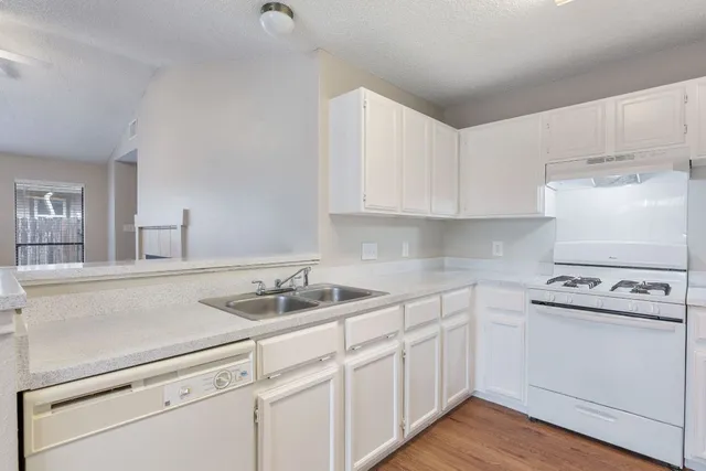a kitchen with a sink and chandelier