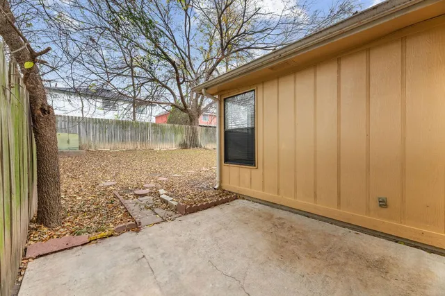 a view of back yard of the house and trees