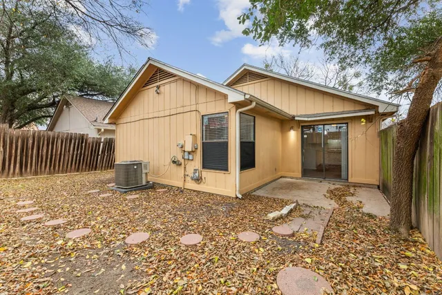 a view of a house with wooden fence