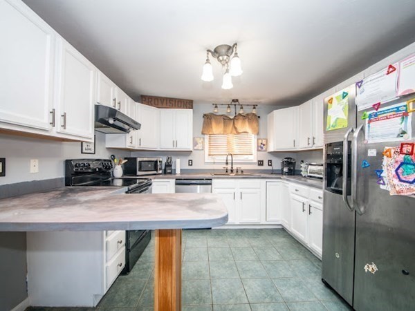 250 Mendall Road Acushnet, MA 02743 - Photo 8 of 25 a kitchen with stainless steel appliances granite countertop a sink a stove and cabinets