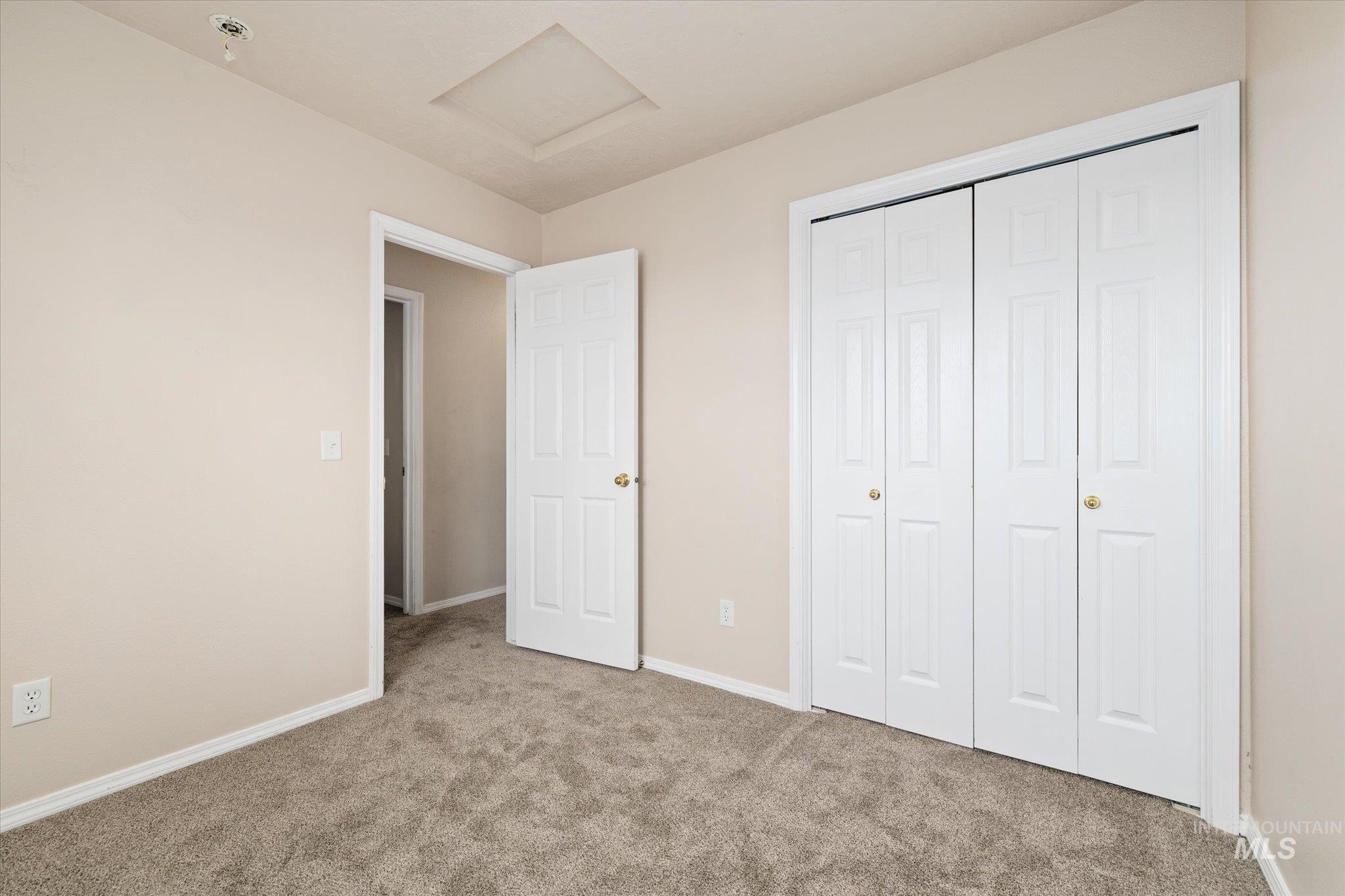 17925 Monarch Way Nampa, ID 83687 - Photo 19 of 29 Unfurnished bedroom with attic access, carpet floors, and a closet