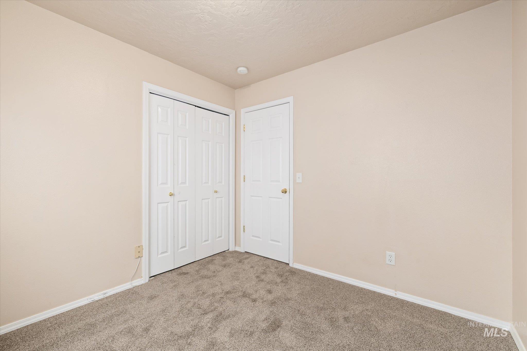 17925 Monarch Way Nampa, ID 83687 - Photo 21 of 29 Unfurnished bedroom featuring carpet flooring, a closet, and a textured ceiling