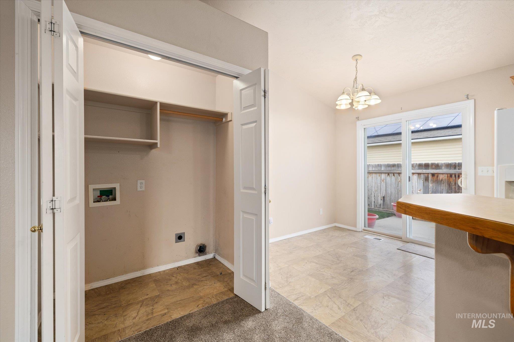 17925 Monarch Way Nampa, ID 83687 - Photo 28 of 29 Washroom featuring a chandelier, washer hookup, electric dryer hookup, and light colored carpet