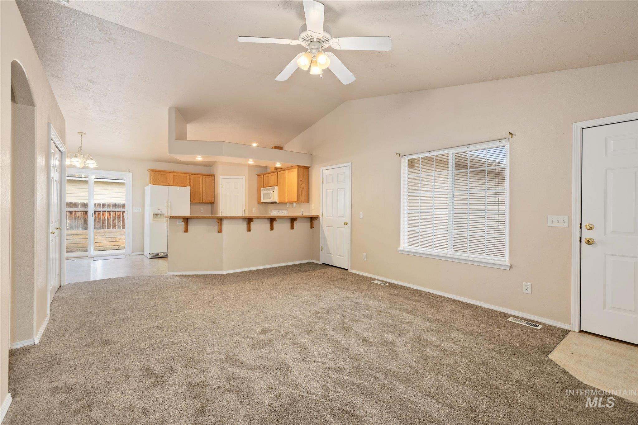 17925 Monarch Way Nampa, ID 83687 - Photo 5 of 29 Unfurnished living room featuring lofted ceiling, ceiling fan, and light colored carpet