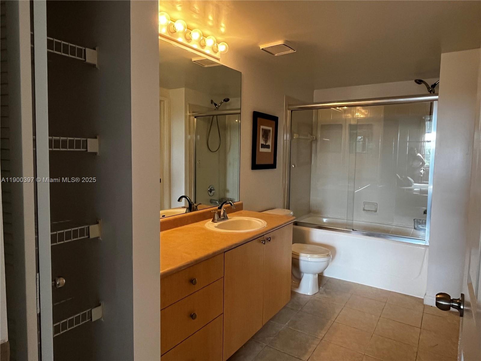 1919 Van Buren Street, Unit 507A Hollywood, FL 33020 - Photo 11 of 13 a bathroom with a granite countertop sink toilet mirror and bathtub