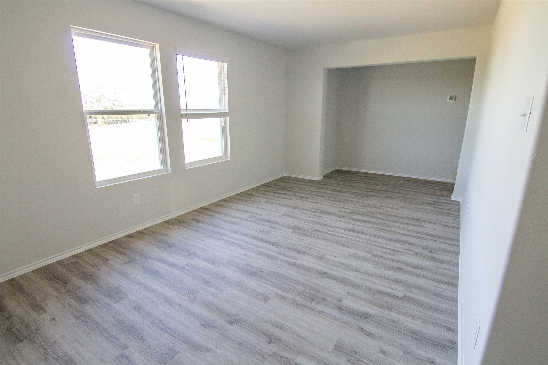 18638 Bell Ravine Drive Katy, TX 77449 - Photo 15 of 19 an empty room with wooden floor and windows