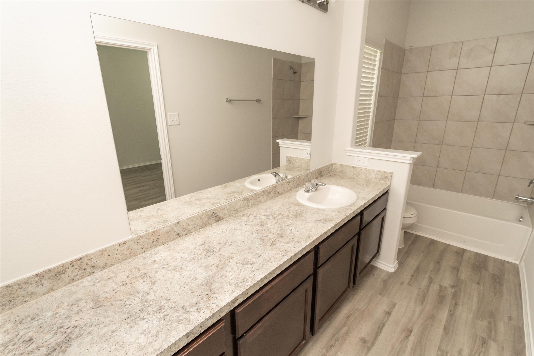 18638 Bell Ravine Drive Katy, TX 77449 - Photo 16 of 19 a bathroom with a granite countertop bathtub sink and mirror