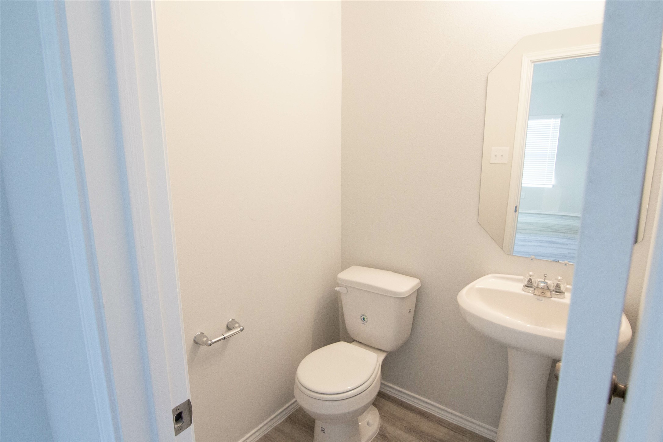 18638 Bell Ravine Drive Katy, TX 77449 - Photo 17 of 19 a white toilet sitting next to a bathroom sink and vanity