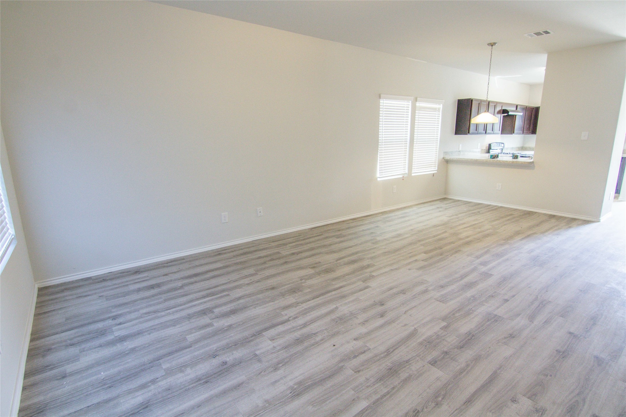 18638 Bell Ravine Drive Katy, TX 77449 - Photo 12 of 19 a view of a kitchen with wooden floor and electronic appliances