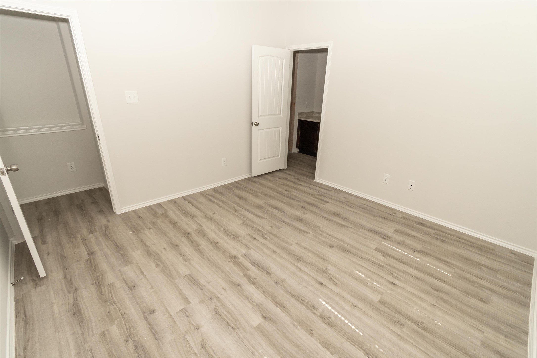 18638 Bell Ravine Drive Katy, TX 77449 - Photo 14 of 19 an empty room with wooden floor and entrance