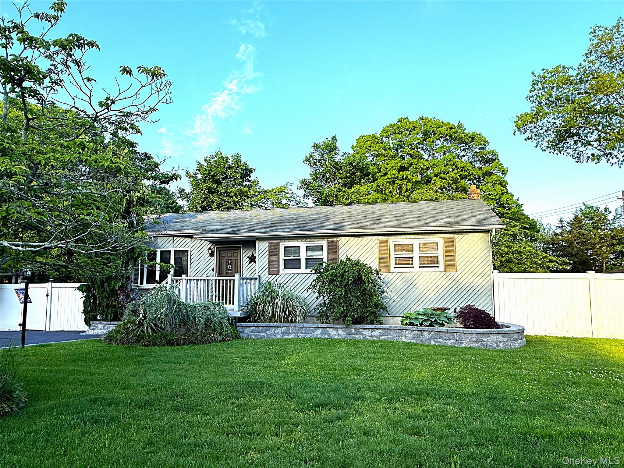 1 Heston Road Shirley, NY 11967 - Photo 3 of 32 Ranch-style residence featuring horizontal siding, a gabled roofline, and a prominent front entrance with a porch