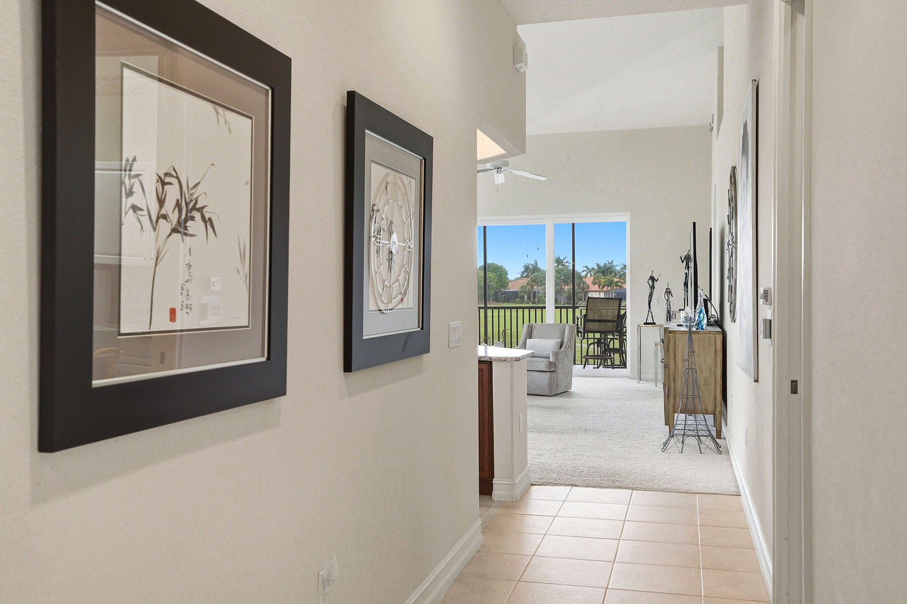 8605 Champions Point, Unit 103 Naples, FL 34113 - Photo 11 of 44 a view of a hallway with wooden floor and a living room
