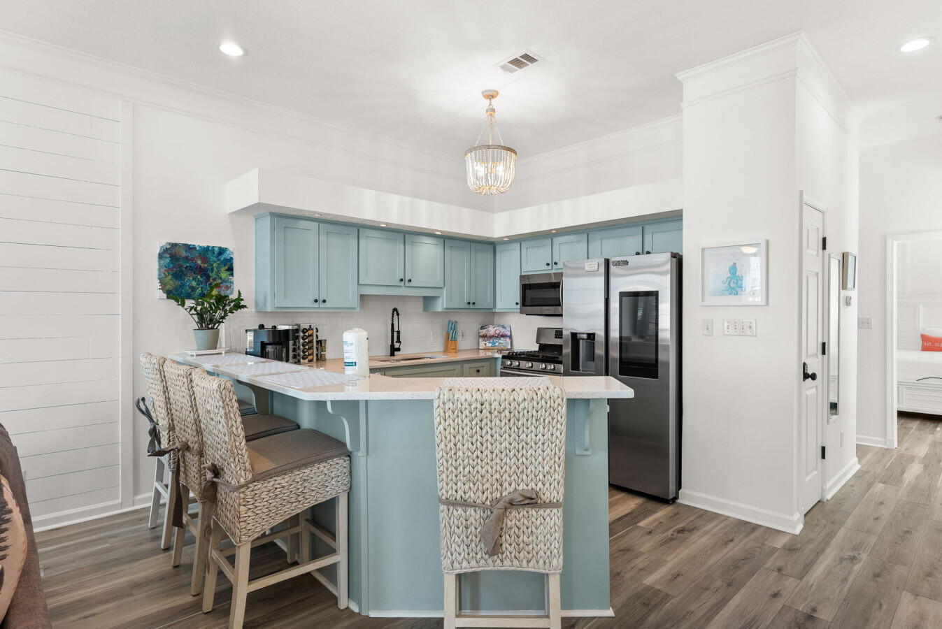 17878 Front Beach Road, Unit A1 Panama City Beach, FL 32413 - Photo 12 of 42 a kitchen with stainless steel appliances granite countertop a center island stools a stove a refrigerator cabinets and a dining table