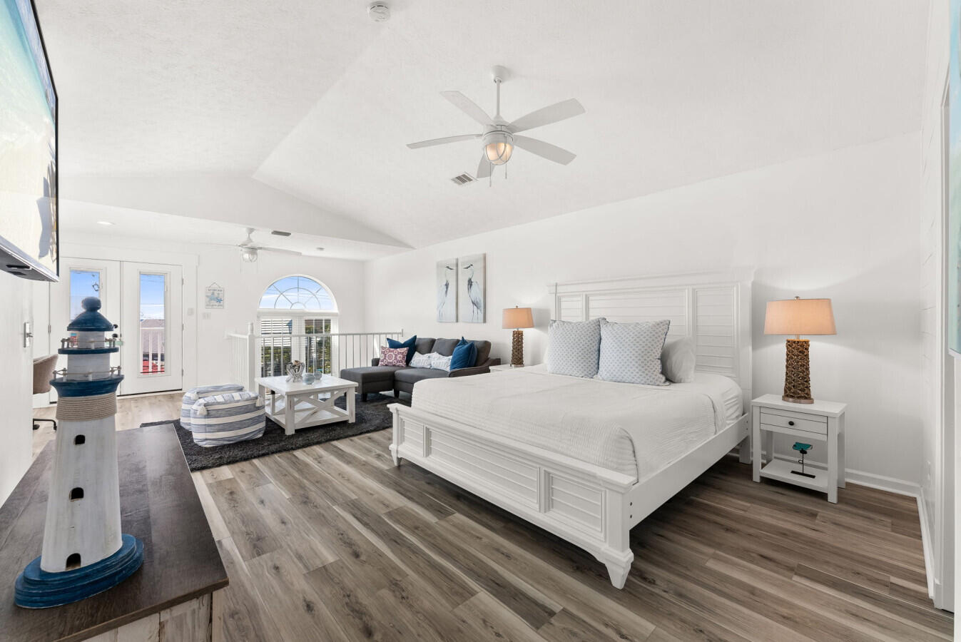 17878 Front Beach Road, Unit A1 Panama City Beach, FL 32413 - Photo 22 of 42 a bedroom with a bed and wooden floor