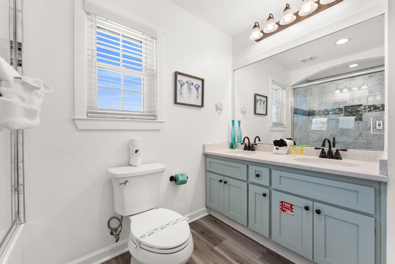 17878 Front Beach Road, Unit A1 Panama City Beach, FL 32413 - Photo 26 of 42 a bathroom with a toilet sink and mirror