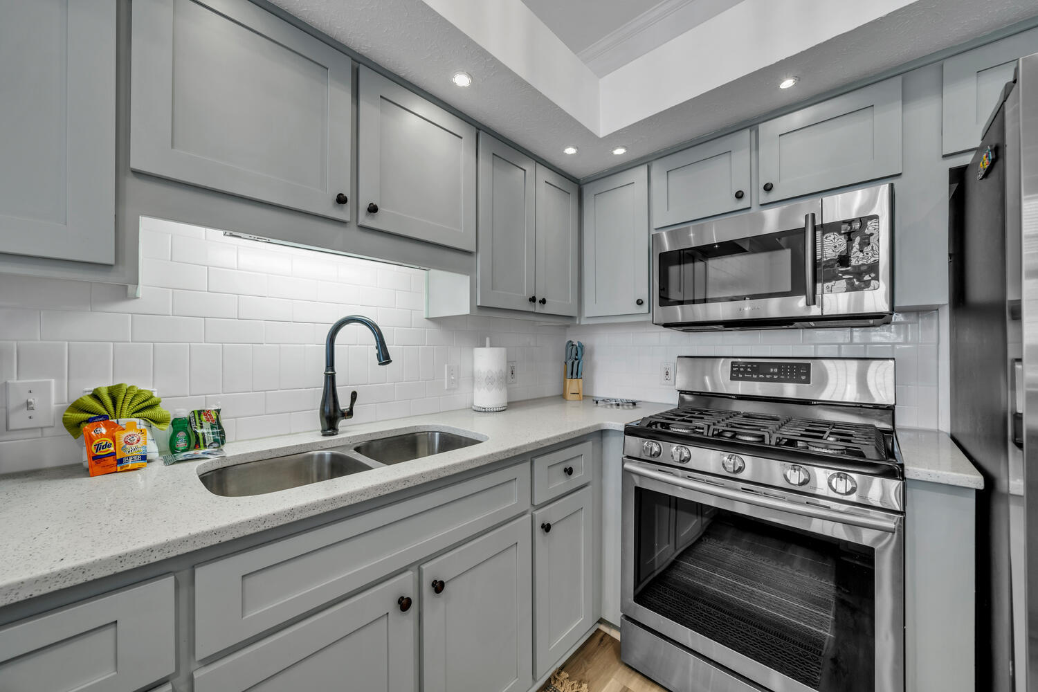 17878 Front Beach Road, Unit A1 Panama City Beach, FL 32413 - Photo 10 of 42 a kitchen with stainless steel appliances a stove a sink a refrigerator and cabinets