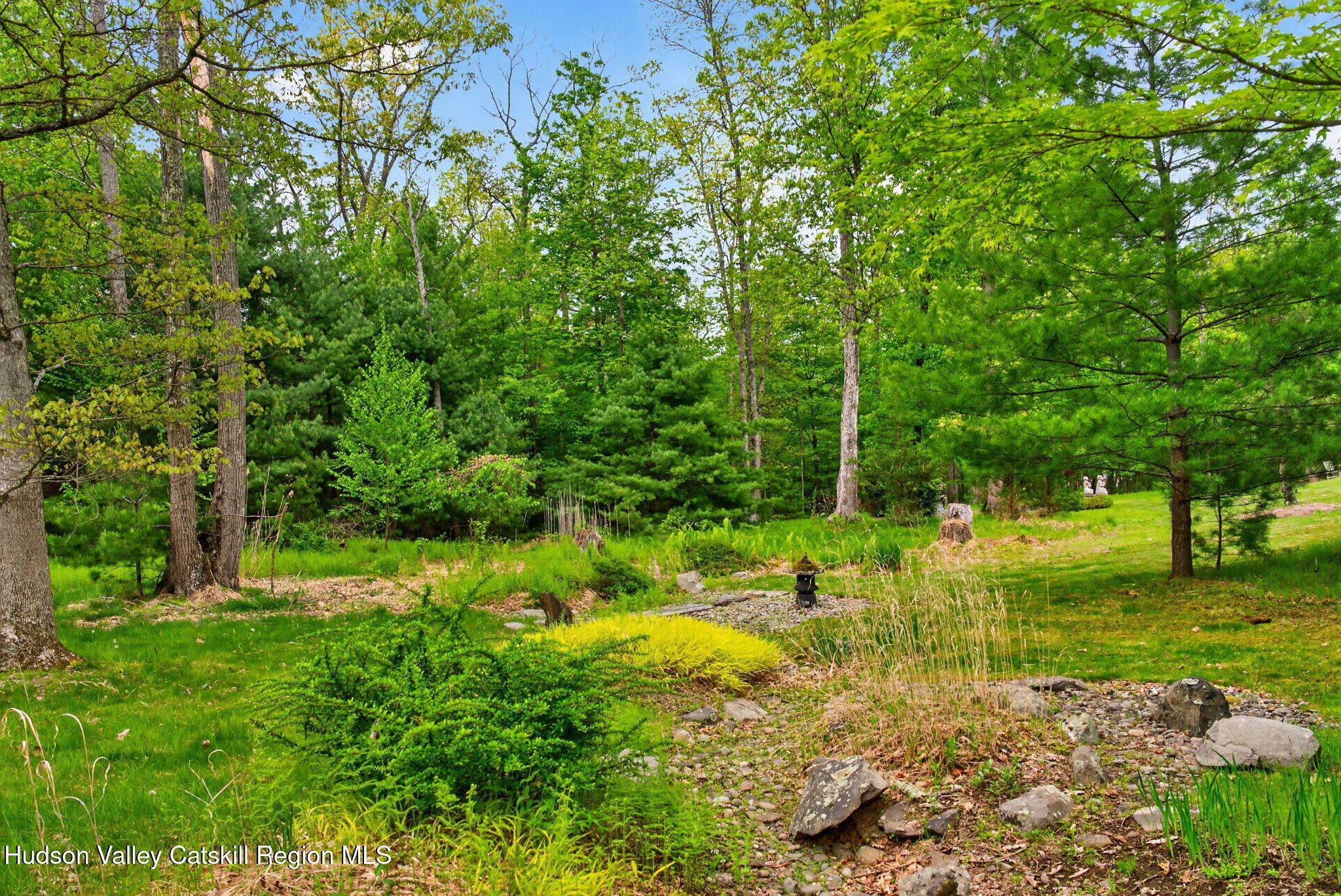 189 Bush Road Stone Ridge, NY 12484 - Photo 48 of 60 a view of a garden with a bench