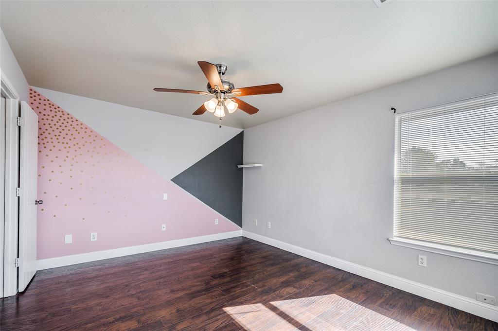 1008 Tennessee Trail Arlington, TX 76017 - Photo 16 of 25 a view of a hallway with wooden floor and a ceiling fan