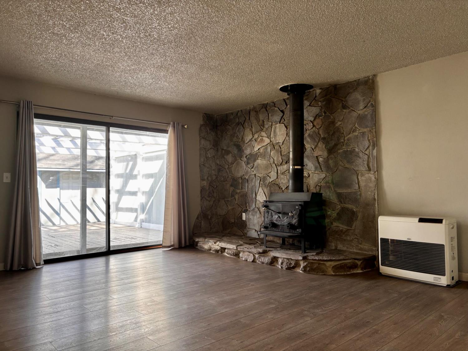 111 Patterson Avenue Loyalton, CA 96118 - Photo 13 of 46 a view of a livingroom with hardwood floor and a fireplace