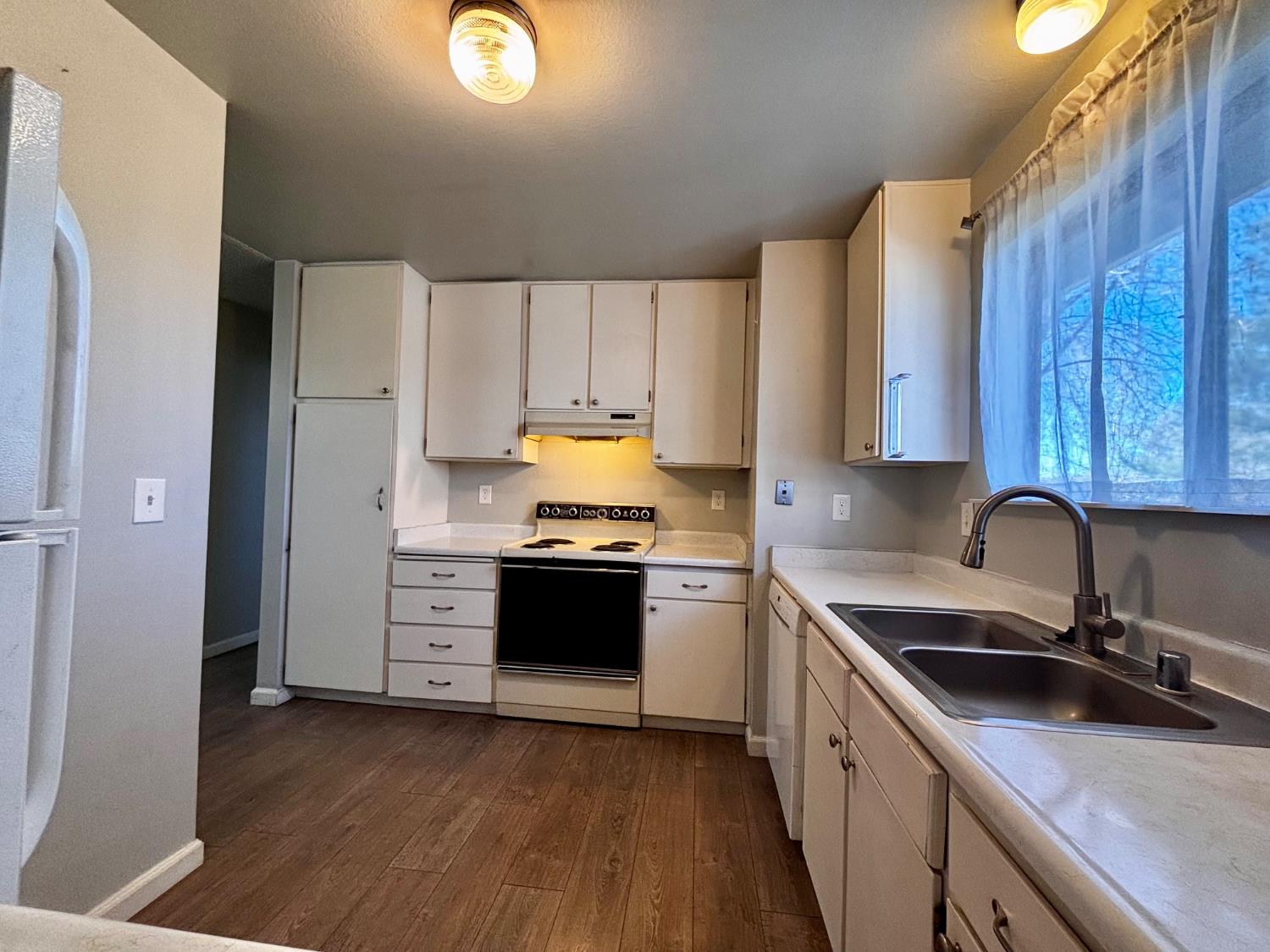 111 Patterson Avenue Loyalton, CA 96118 - Photo 16 of 45 a kitchen with stainless steel appliances granite countertop a sink stove and refrigerator