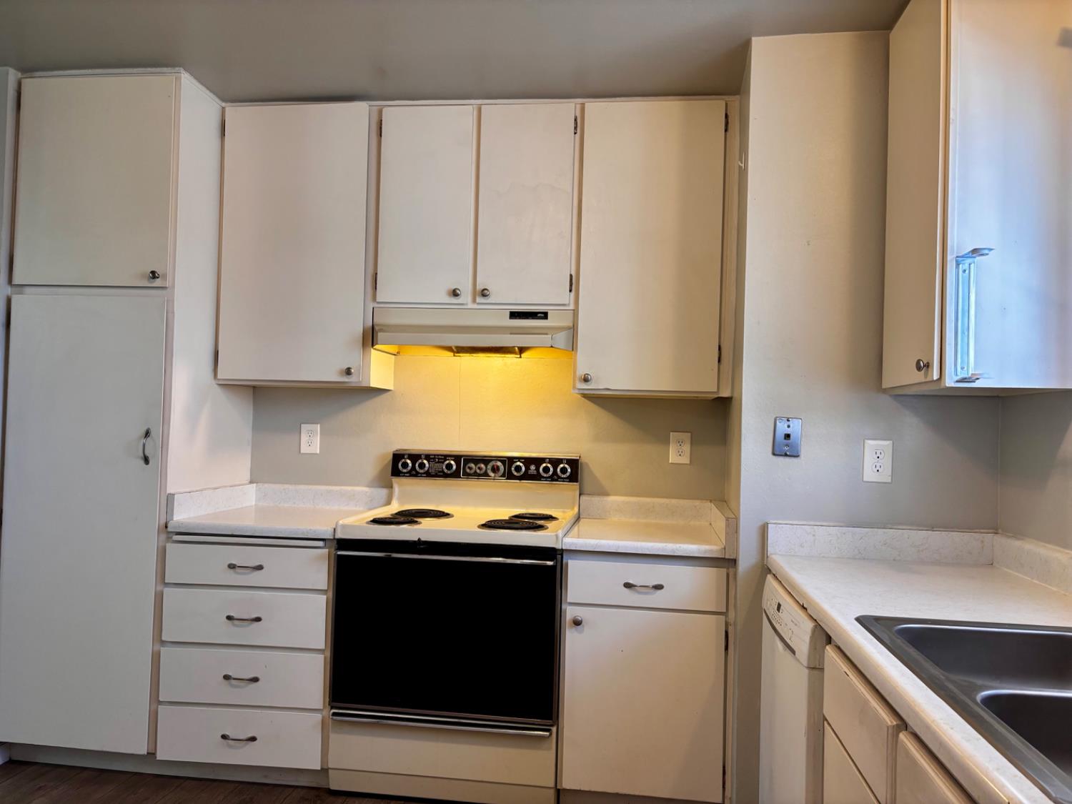 111 Patterson Avenue Loyalton, CA 96118 - Photo 19 of 45 a kitchen with stainless steel appliances white cabinets and a stove top oven