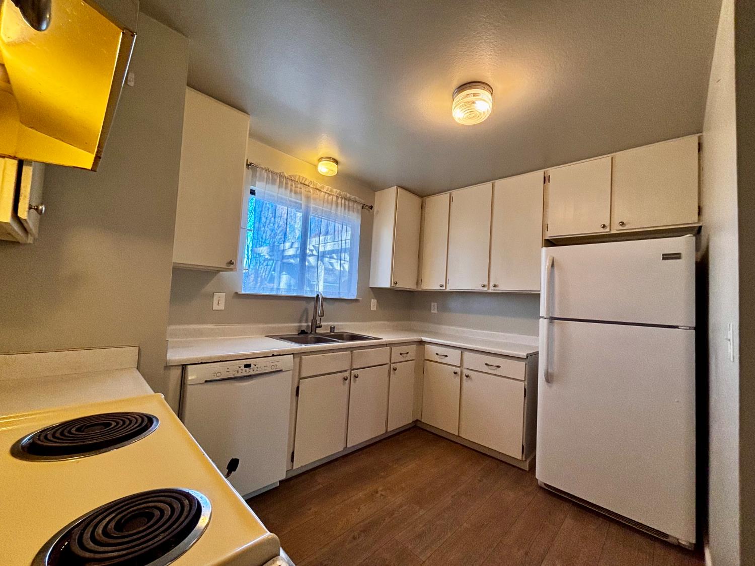 111 Patterson Avenue Loyalton, CA 96118 - Photo 21 of 46 a kitchen with a sink a refrigerator and cabinets
