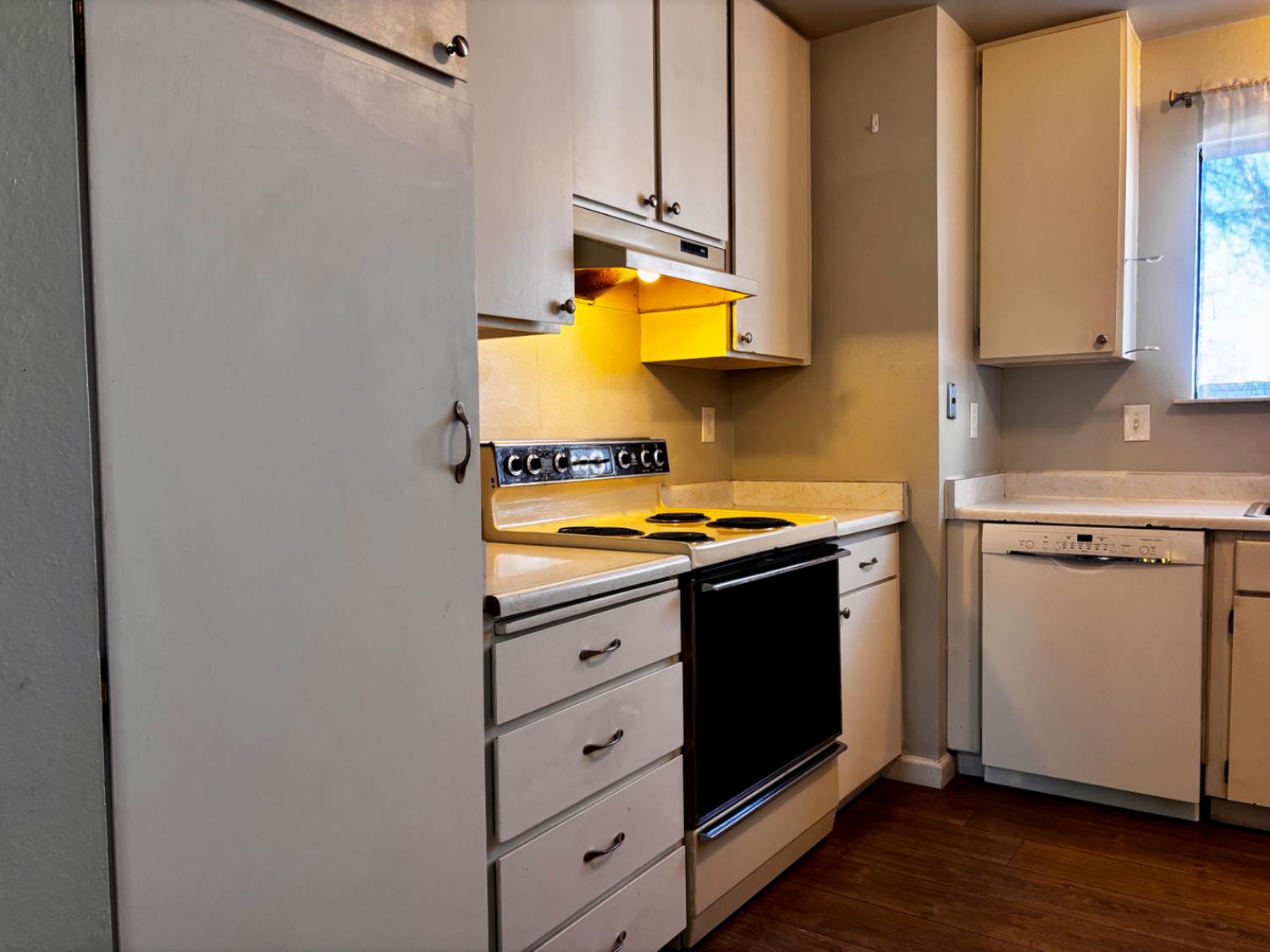 111 Patterson Avenue Loyalton, CA 96118 - Photo 21 of 45 a kitchen with stainless steel appliances granite countertop a sink and a stove with wooden floor
