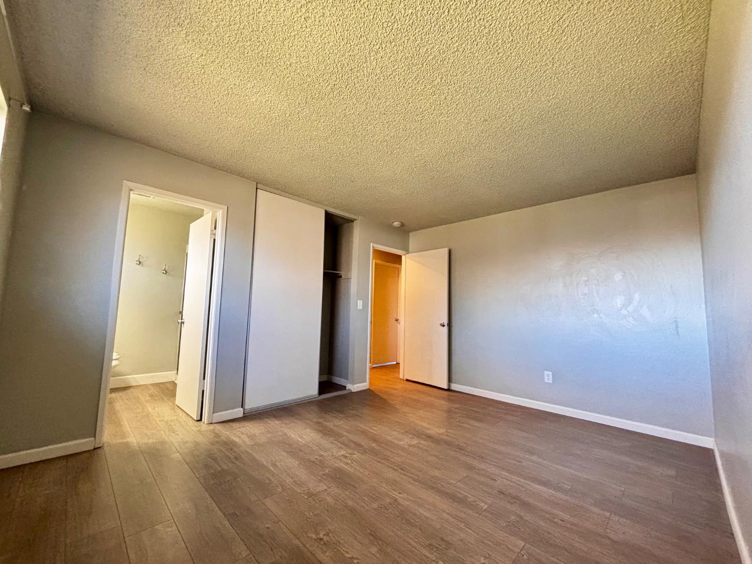 111 Patterson Avenue Loyalton, CA 96118 - Photo 28 of 46 an empty room with wooden floor and windows
