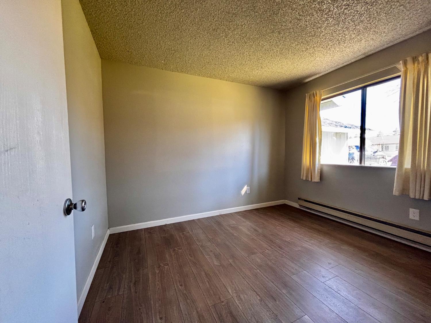111 Patterson Avenue Loyalton, CA 96118 - Photo 32 of 45 an empty room with wooden floor and windows