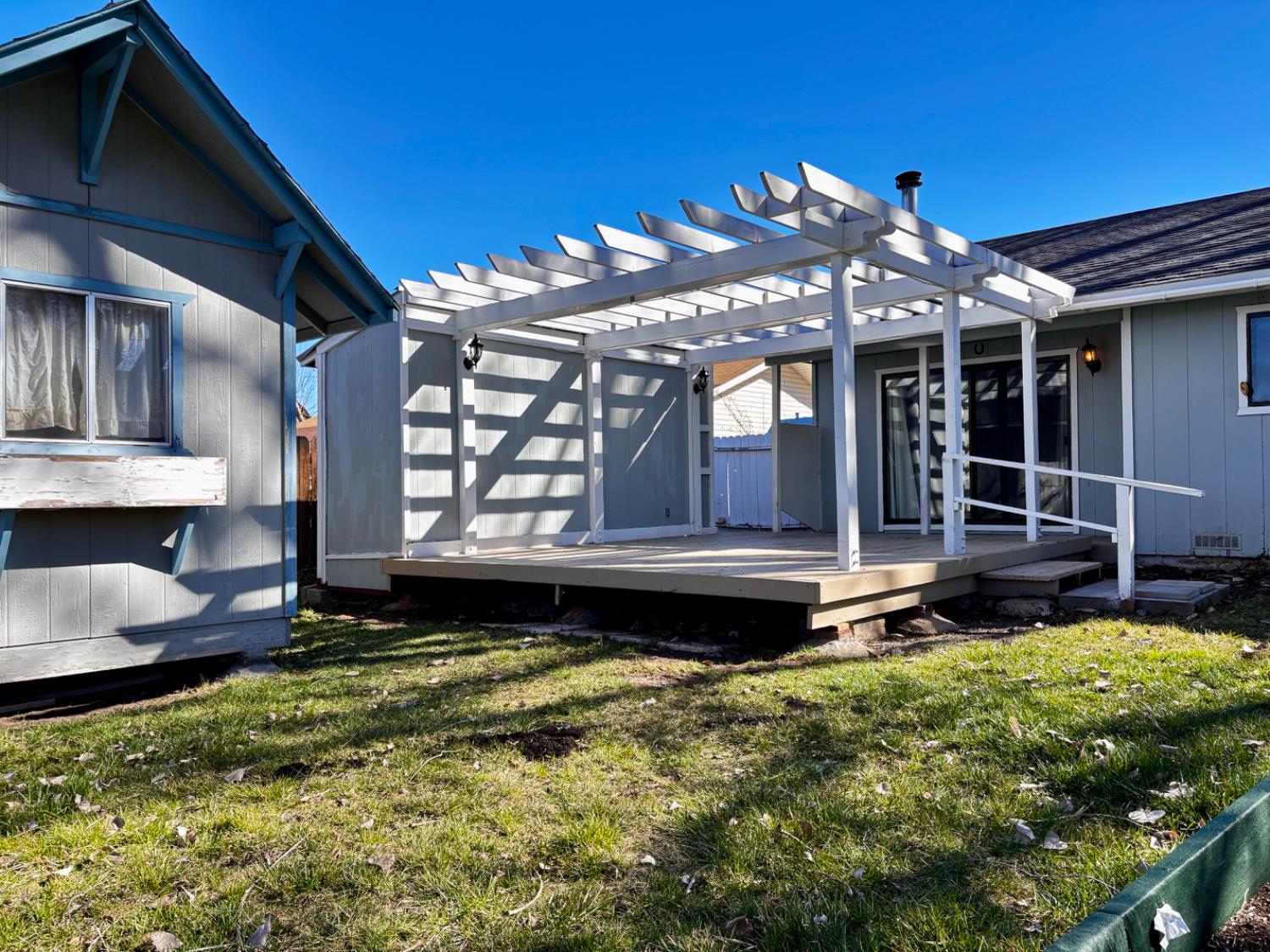 111 Patterson Avenue Loyalton, CA 96118 - Photo 35 of 45 a view of a house with a large window potted plants and a table