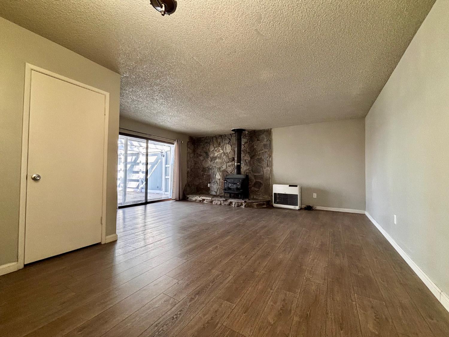 111 Patterson Avenue Loyalton, CA 96118 - Photo 7 of 46 a view of empty room with wooden floor and fan