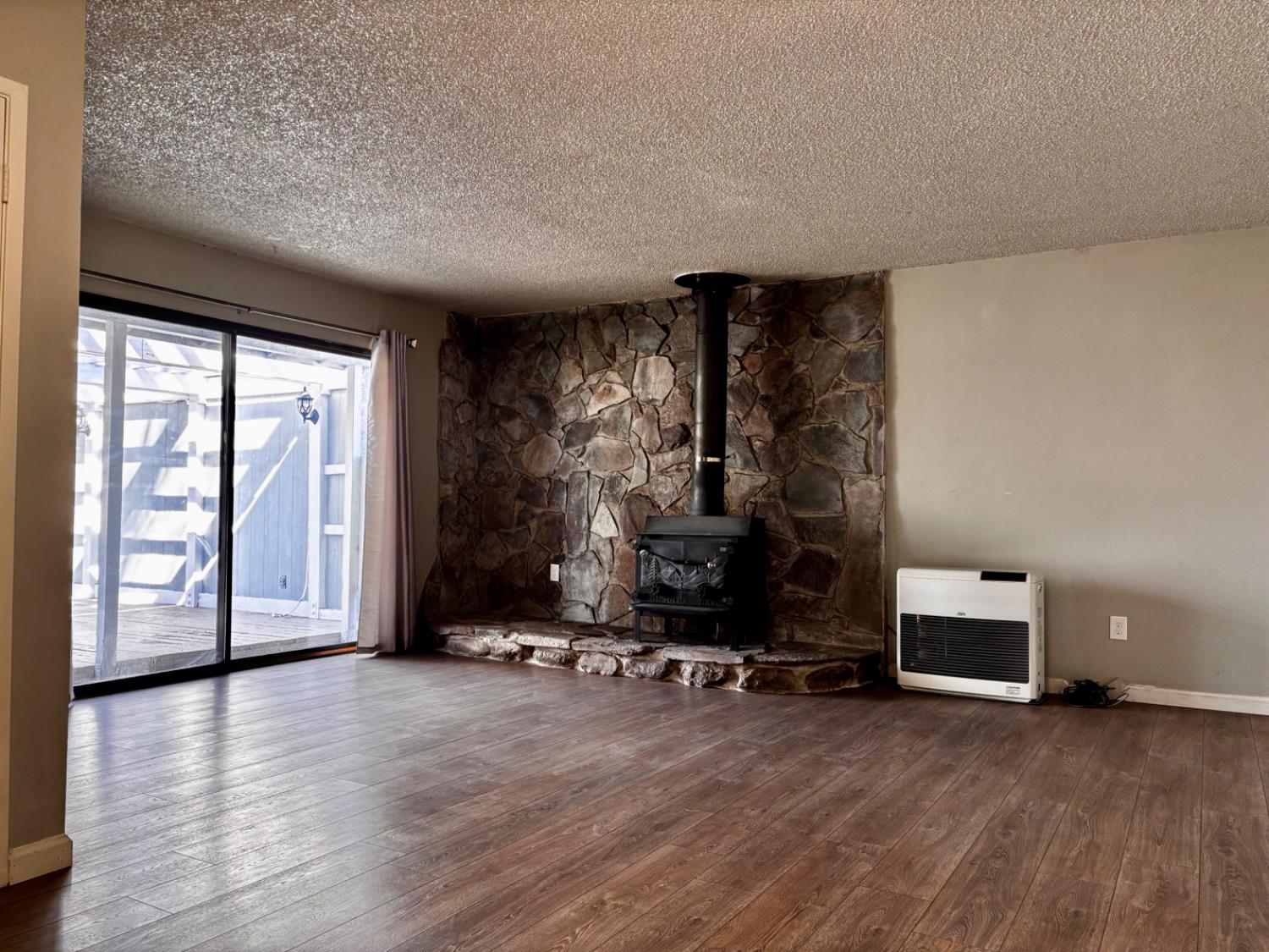 111 Patterson Avenue Loyalton, CA 96118 - Photo 9 of 45 a view of a room with gym equipment and a fireplace