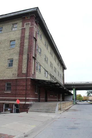 a front view of a building with parking