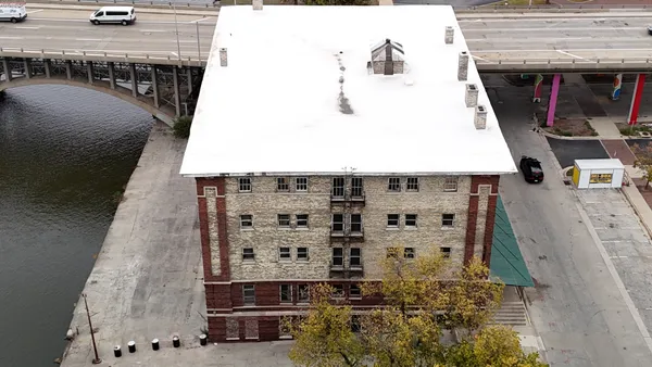 a view of a hall with wooden floor